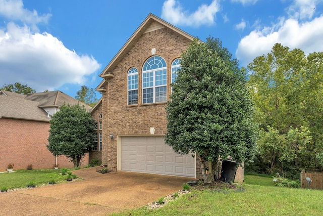 view of front of home featuring a front lawn and a garage