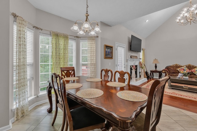 dining space featuring lofted ceiling, a chandelier, and light tile patterned floors