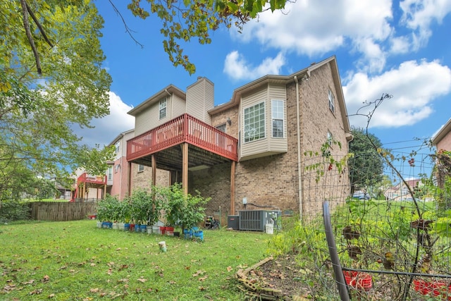 rear view of house featuring a yard, central AC, and a deck