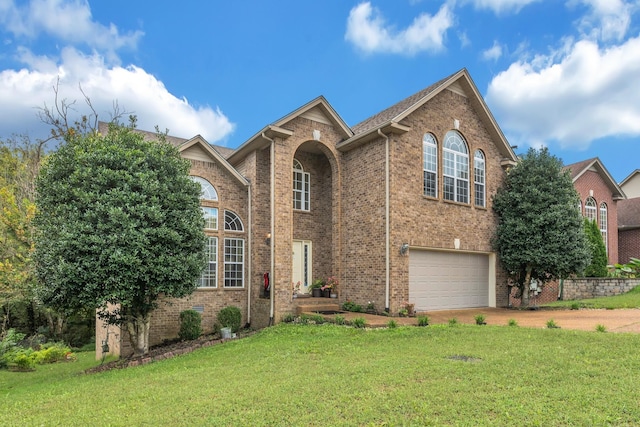 view of property featuring a front yard and a garage