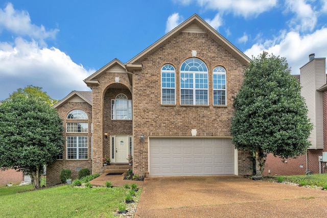 view of property with a front yard and a garage