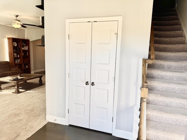 stairs with ceiling fan and hardwood / wood-style floors