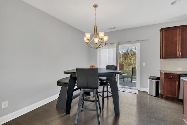 dining area with a notable chandelier and dark hardwood / wood-style floors