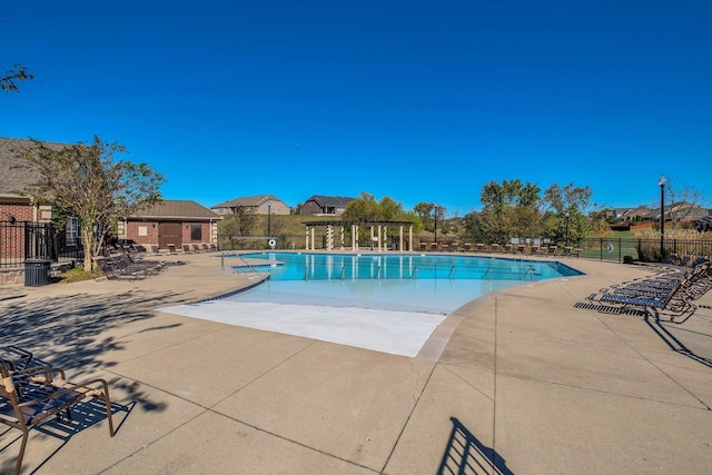 view of swimming pool featuring a patio and a pergola