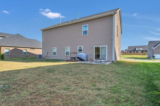 back of property featuring central AC, a yard, and a patio area