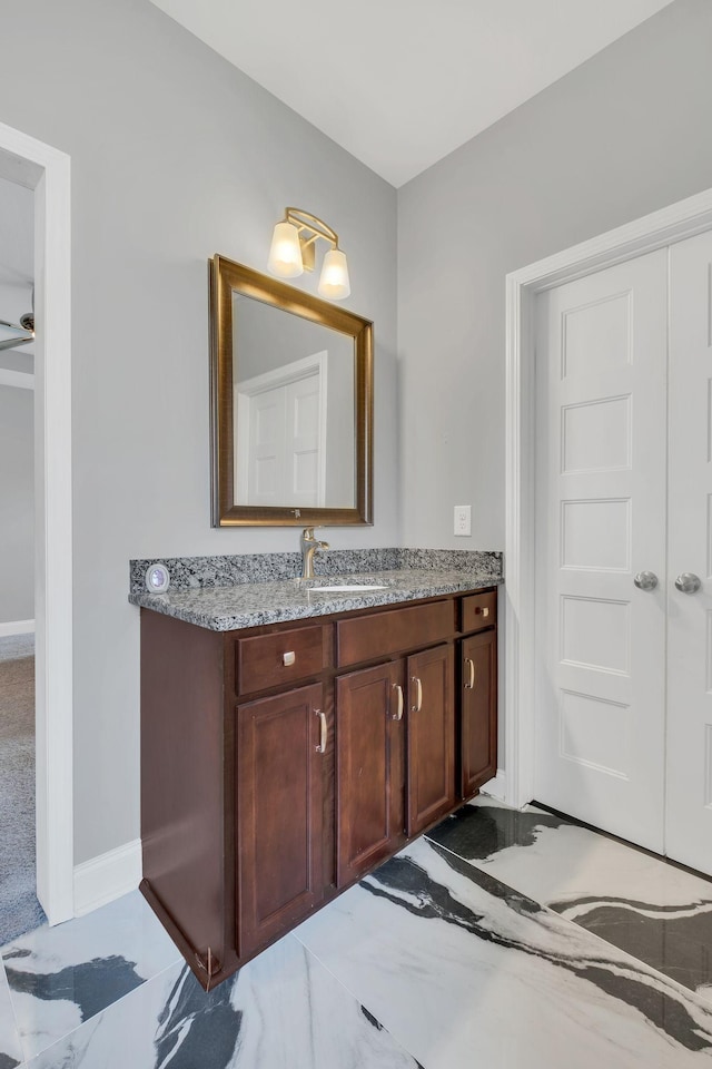 bathroom with ceiling fan and vanity