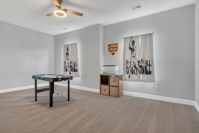 playroom with ceiling fan and carpet flooring