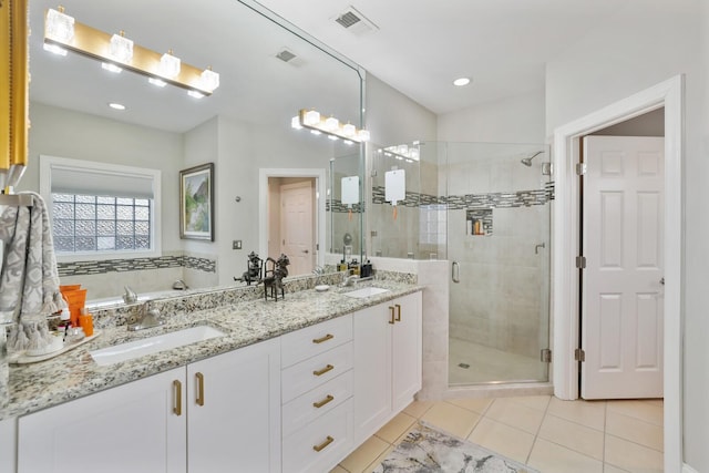 bathroom featuring vanity, tile patterned flooring, and a shower with shower door