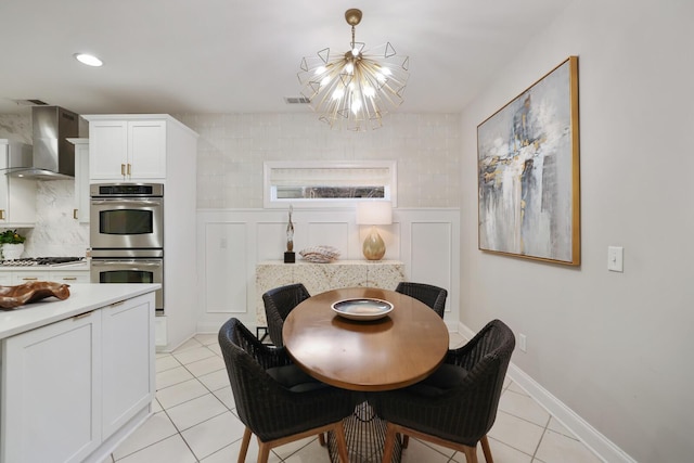 dining room featuring light tile patterned flooring and a chandelier