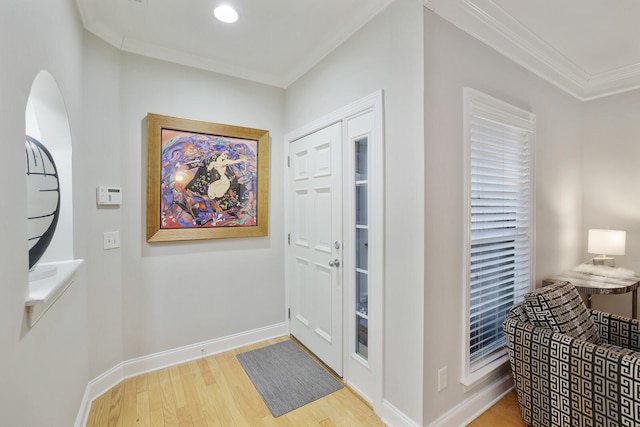 foyer entrance featuring wood-type flooring and ornamental molding