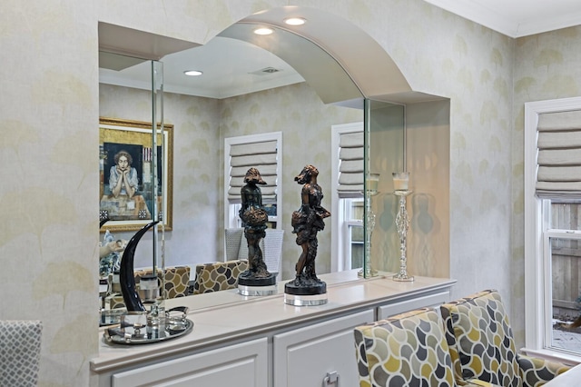 bar featuring white cabinets and ornamental molding