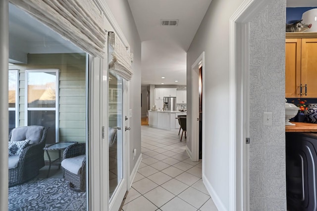 corridor with light tile patterned floors