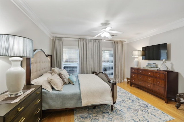 bedroom with ceiling fan, light wood-type flooring, and crown molding