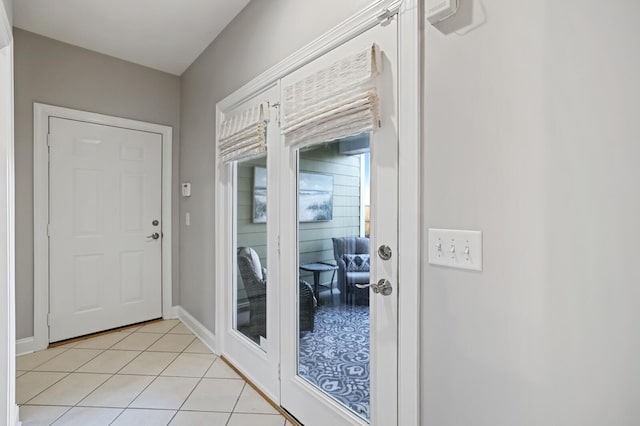 doorway to outside with light tile patterned floors