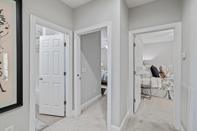 hallway with light colored carpet