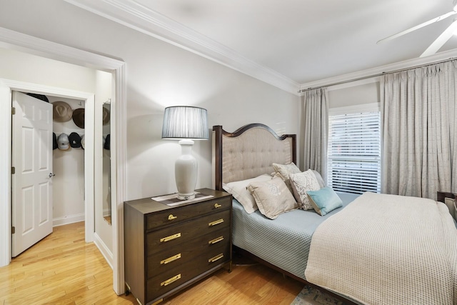 bedroom with ornamental molding and light hardwood / wood-style flooring