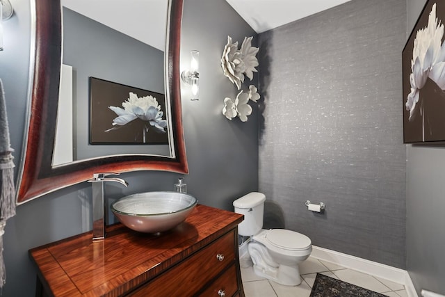 bathroom featuring toilet, vanity, and tile patterned floors