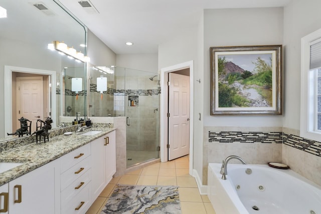 bathroom with shower with separate bathtub, tile patterned floors, and vanity