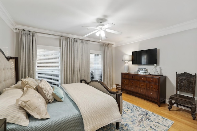 bedroom with ceiling fan, light hardwood / wood-style floors, and ornamental molding