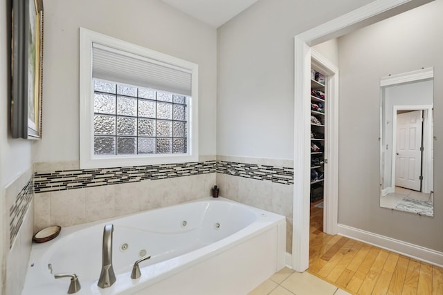 bathroom with tile patterned flooring and a bathtub