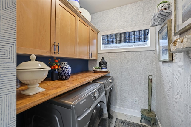 laundry area with cabinets, separate washer and dryer, and tile patterned floors