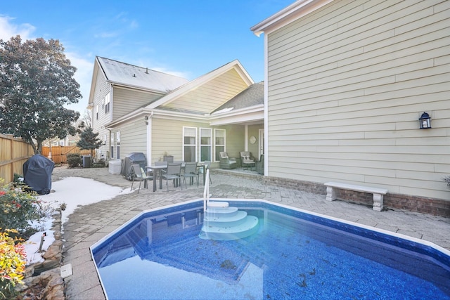 view of pool with a grill and a patio area