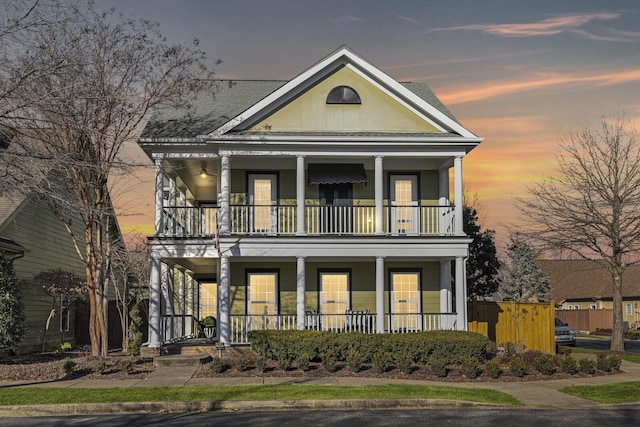 view of front of property with covered porch and a balcony