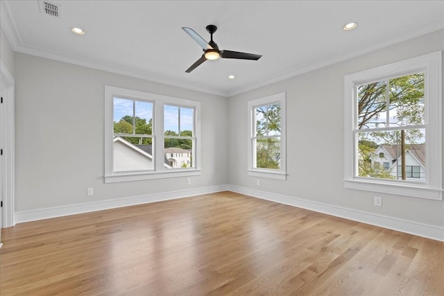 empty room with ceiling fan, light hardwood / wood-style flooring, crown molding, and plenty of natural light