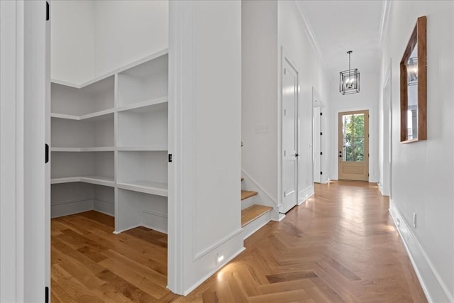 interior space with light parquet flooring and ornamental molding