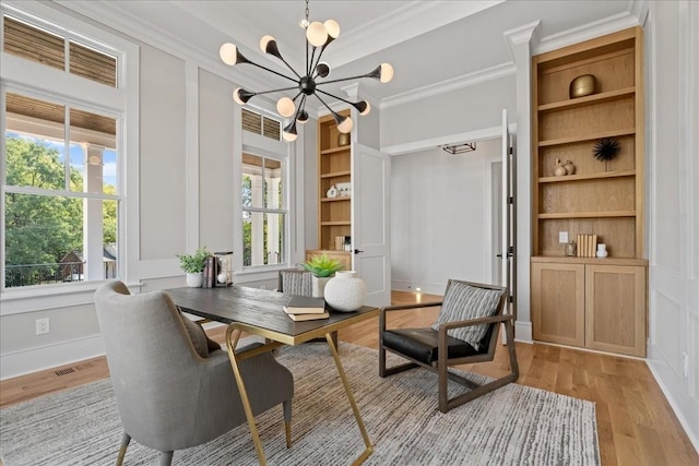 living area featuring ornamental molding, built in features, light hardwood / wood-style floors, and a chandelier