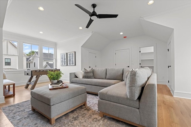 living room with ceiling fan, ornamental molding, and light hardwood / wood-style flooring