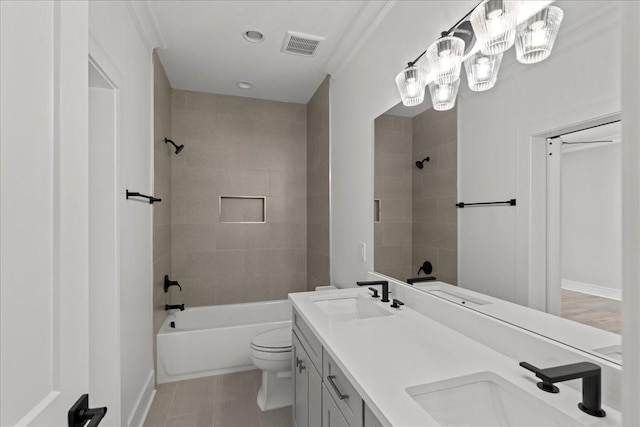 full bathroom featuring tiled shower / bath, tile patterned flooring, toilet, vanity, and crown molding