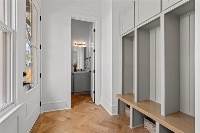 mudroom with a healthy amount of sunlight and light parquet floors