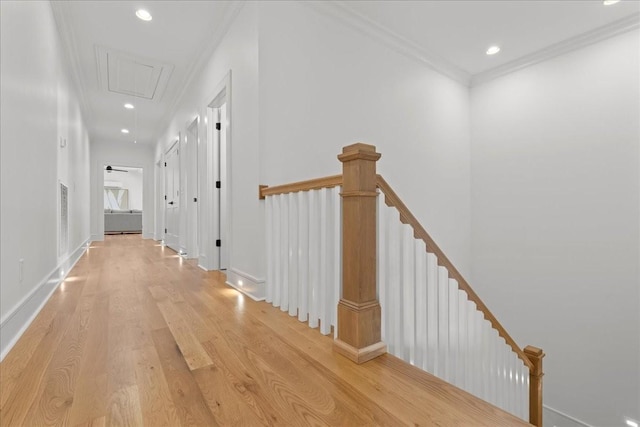 corridor featuring ornamental molding and light hardwood / wood-style floors