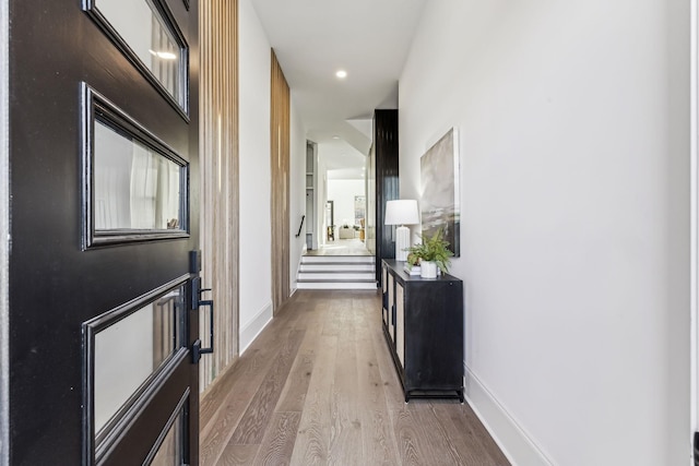 hall with hardwood / wood-style flooring