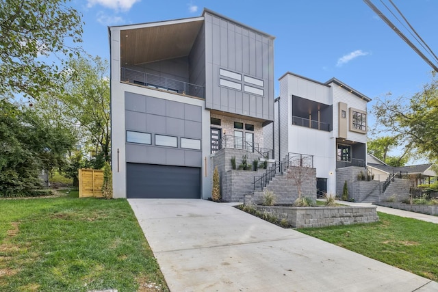 contemporary home with a front yard and a garage