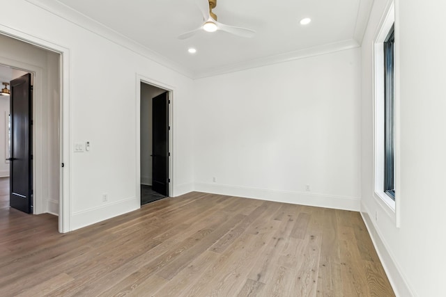 empty room featuring ceiling fan, light hardwood / wood-style flooring, and crown molding