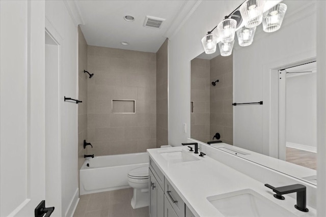 full bathroom with tile patterned flooring, ornamental molding, toilet, vanity, and tiled shower / bath combo