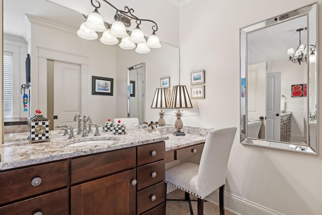 bathroom featuring vanity, an inviting chandelier, and crown molding