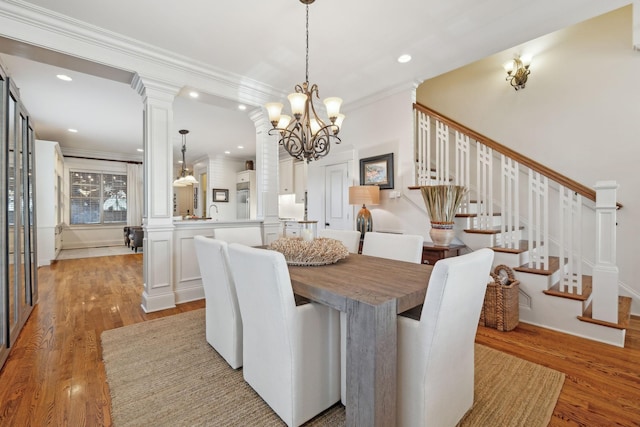 dining room featuring light hardwood / wood-style flooring, an inviting chandelier, and crown molding