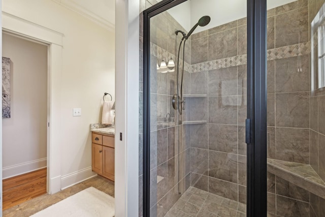 bathroom featuring an enclosed shower, vanity, hardwood / wood-style floors, and crown molding