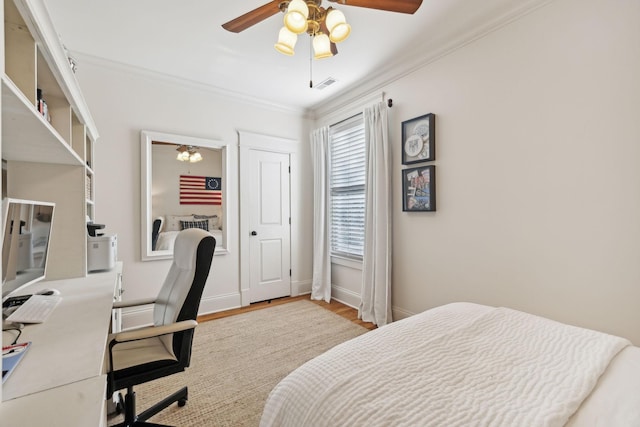 bedroom with ceiling fan, light hardwood / wood-style flooring, and ornamental molding