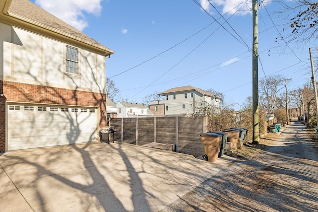 view of patio / terrace with a garage and a grill