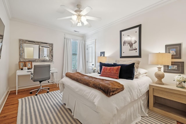 bedroom with ceiling fan, crown molding, and hardwood / wood-style floors