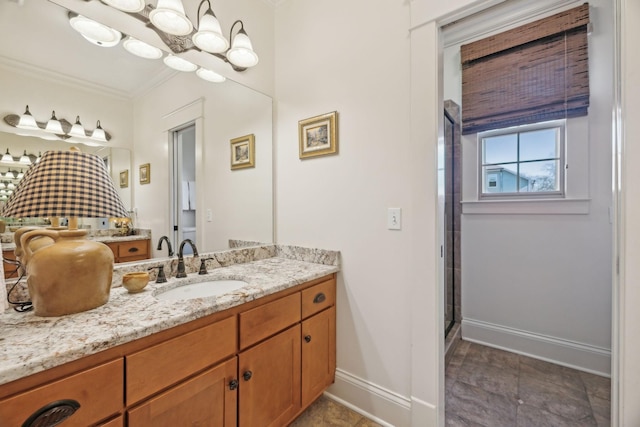 bathroom featuring a shower with door, vanity, a chandelier, and crown molding