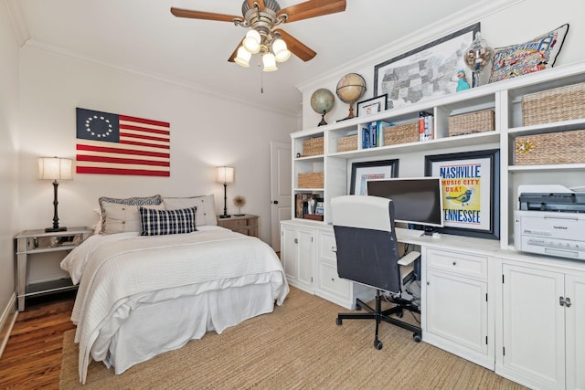 bedroom featuring ceiling fan, light wood-type flooring, and crown molding