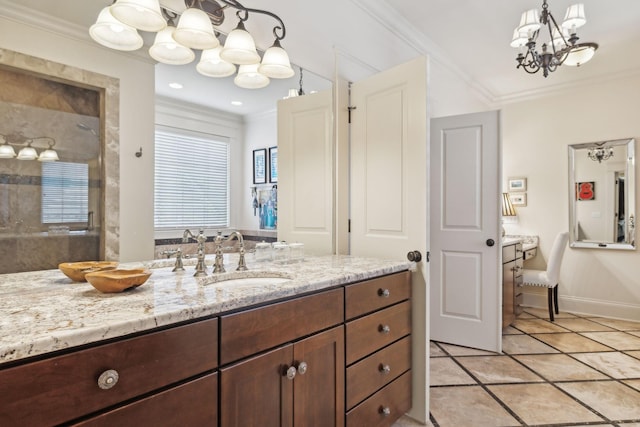 bathroom with ornamental molding, vanity, tile patterned flooring, and a chandelier