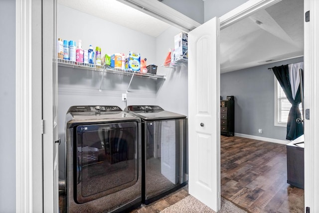 laundry area featuring washer and clothes dryer and hardwood / wood-style floors