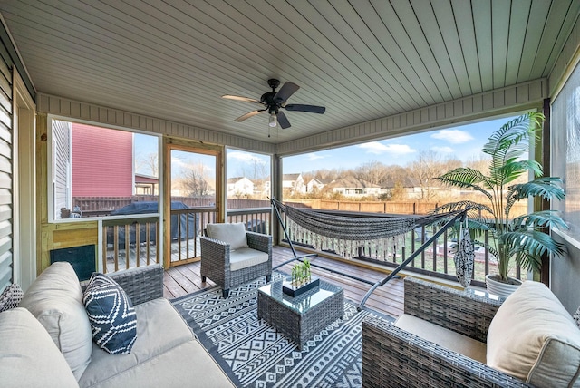 sunroom / solarium featuring ceiling fan