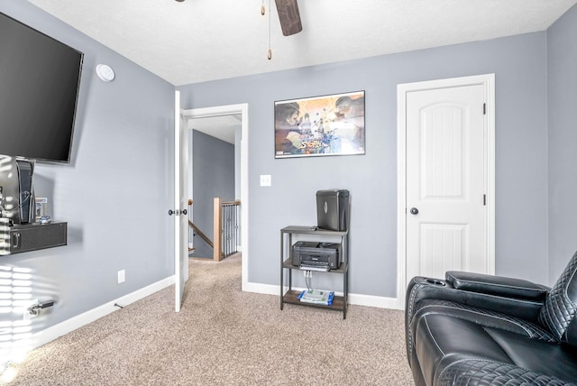 carpeted living room featuring a textured ceiling and ceiling fan